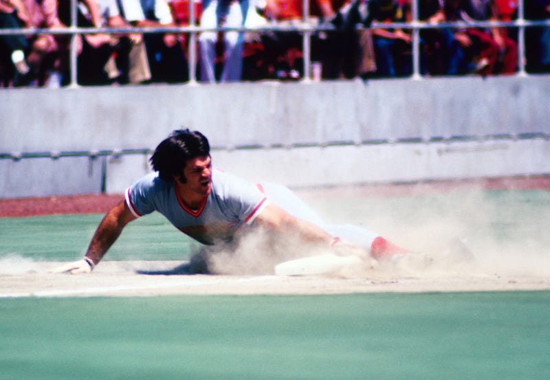 Cincinnati Reds outfielder Pete Rose slides into third during the 1974 season.