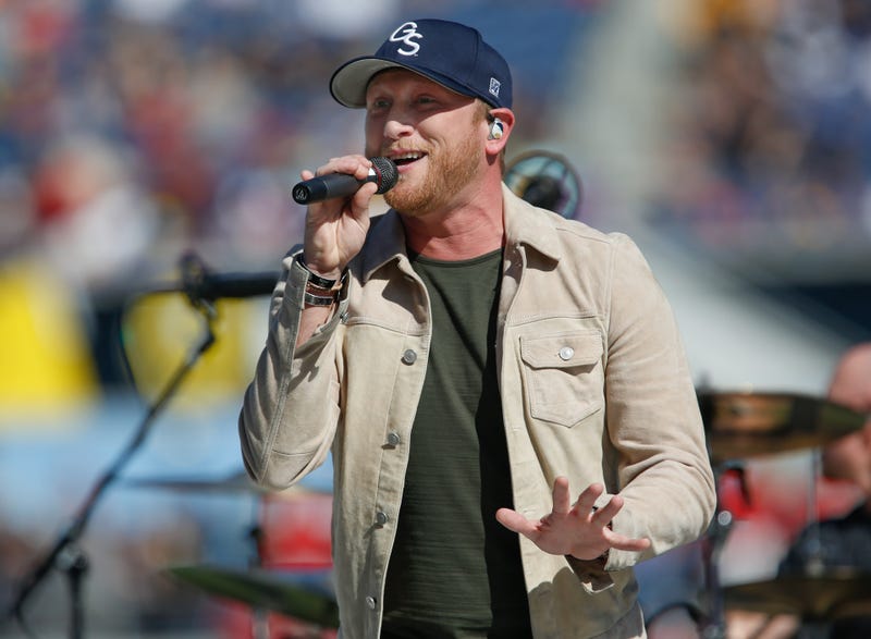 Cole Swindell performs a halftime show during an NCAA football game between the LSU Tigers and the Louisville Cardinals in the Buffalo Wild Wings Citrus Bowl at Camping World Stadium