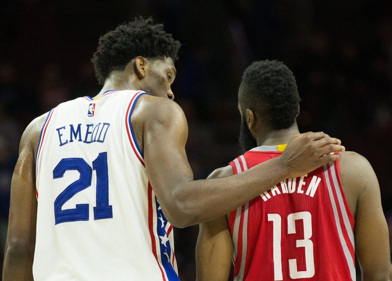 Joel Embiid puts his arm around James Harden.