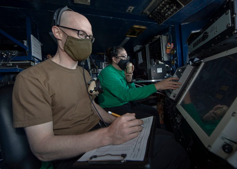 Aviation Boatswain's Mate (Equipment) 2nd Class Grady Cartlidge (left), from Easley, S.C., and Interior Communications Electrician 3rd Class Patricia Beltran (right), from Los Angeles, man recovery stations in primary flight control of the aircraft carrier USS Nimitz (CVN 68)