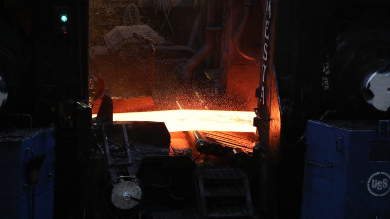 A slab of steel moves through the hot strip mill