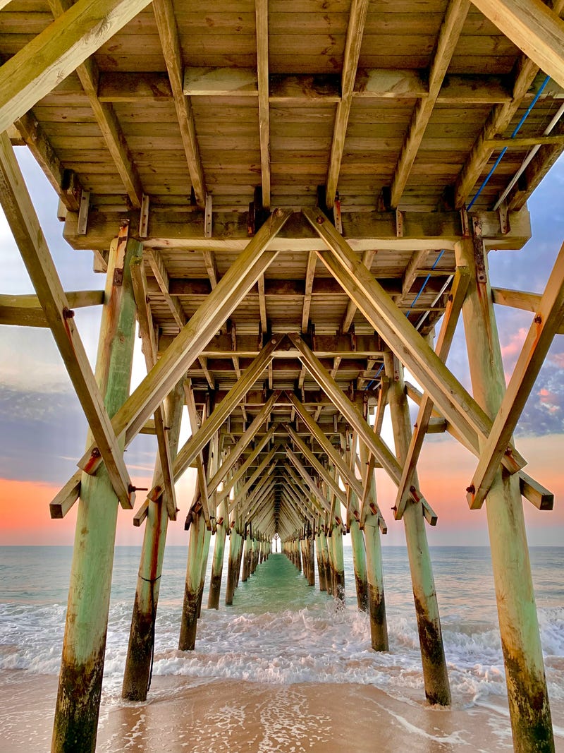 Underneath the Surf City pier at sunrise