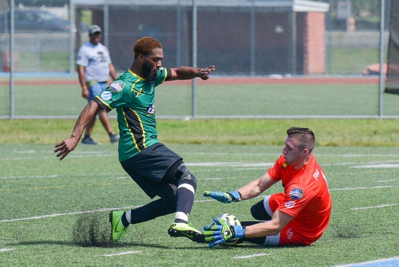 A goalkeeper attempting to block a shot during the Photo credit Philadelphia International Unity Cup.