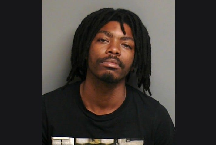A 25-year-old has been charged with three counts of weapons and trespassing charges after he was arrested for scaling a fence and trespassing on a military base in Harrison Township.