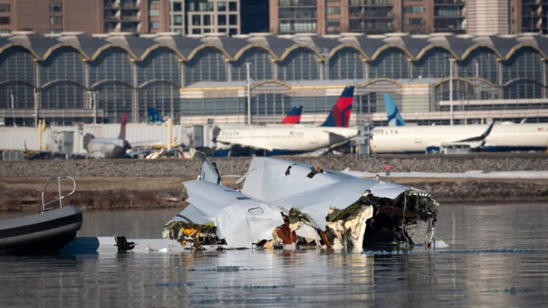 The U.S. Coast Guard investigates aircraft wreckage on the Potomac River in Washington, D.C., on Thursday after an American Airlines from Wichita, Kansas, collided midair with a military Black Hawk helicopter while on approach to Ronald Reagan Washington National Airport Wednesday night. 
