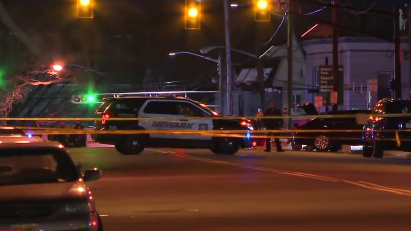Caution tape and police cars at scene of shooting that left one officer dead and another injured on March 7, 2025 in Newark, New Jersey.