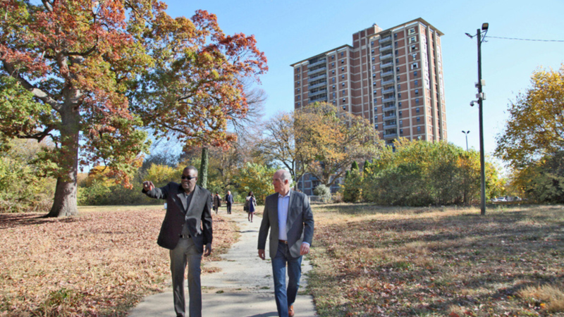 Former U.S. Sen. Bob Casey and Philadelphia Housing Authority President Kelvin Jeremiah are shown last year walking the campus of Westpark Apartments, a public housing site that is being updated into modern, affordable housing