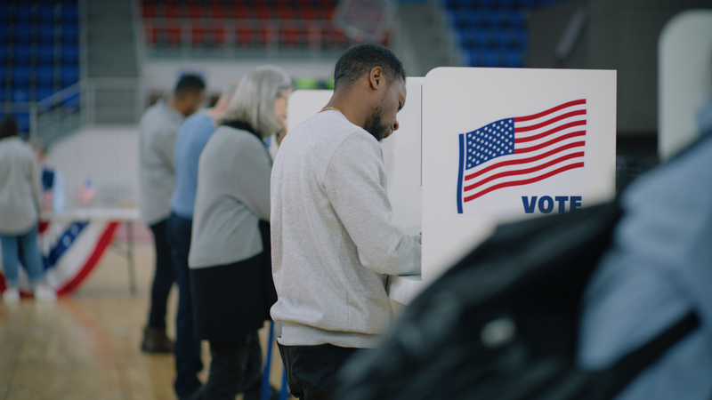 People voting inside booths on election day