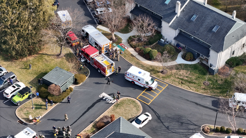 Birds-eye view of fire crews responding to basement fire inside townhouse in Easttown Township, Chester County