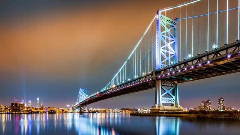 Ben Franklin Bridge and Philadelphia skyline by night as viewed from Camden across the Delaware river