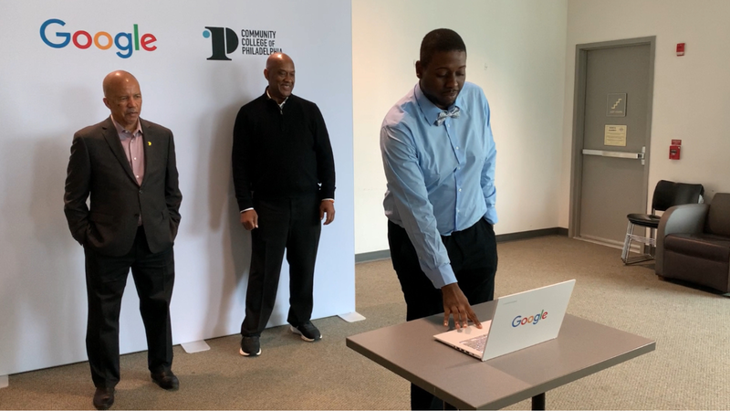 CCP grad Jaquayvius Coleman demonstrates his IT skills as CCP President Dr. Donald “Guy” Generals (left) and U.S. Rep. Dwight Evans (right) look on.