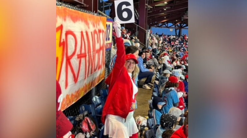 Beth Overmier holding a no. 6 sign at a Phillies game