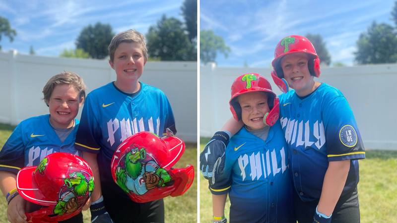 Max and LJ Schembri of Bucks County wearing custom made Phillies helmets from a family friend.