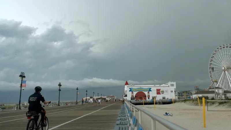 An Ocean City police officer patrols on a bike on the boardwalk, July 25, 2023.