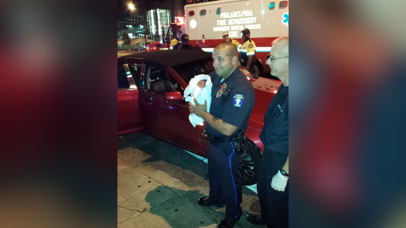 officer holding baby on broad