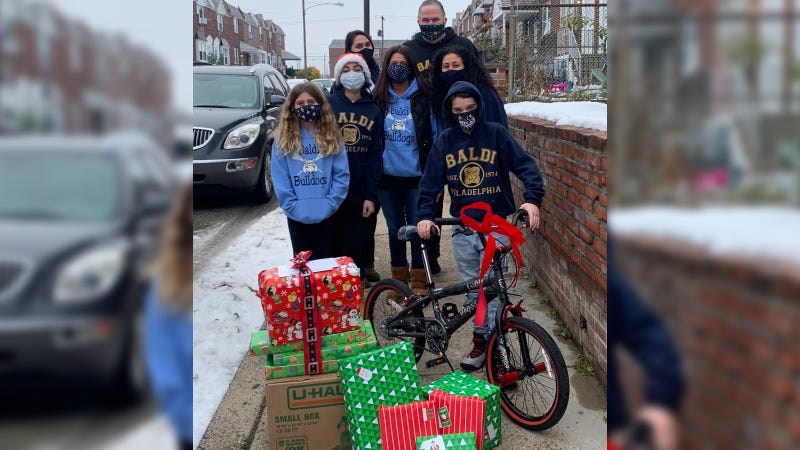 Staff at Baldi Middle School deliver presents to families 
