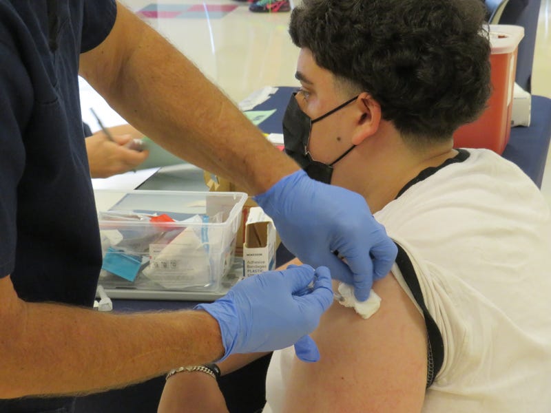 A patient receives a COVID-19 vaccine at a City of Hartford Clinic at the Learning Corridor, 8/20/21