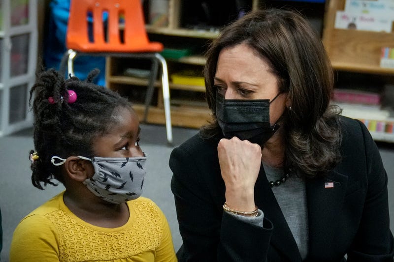 Vice President Kamala Harris sitting on the floor, chatting with a preschool student at West Haven Child Development Center, 3/26/21