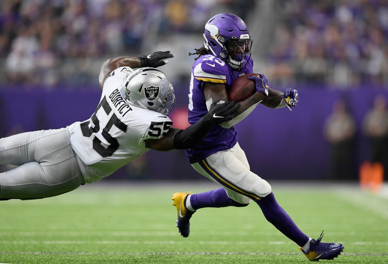 LB Vontaze Burfict attempts a diving tackle on Dalvin Cook.