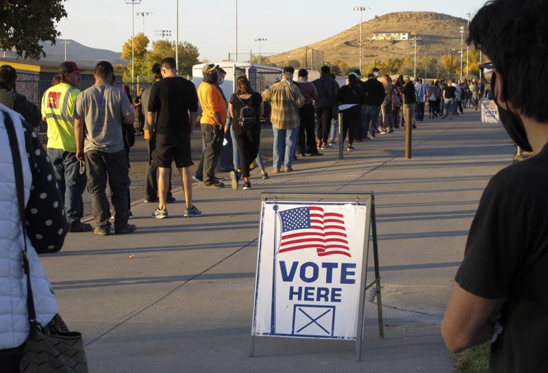 People wait in line to vote