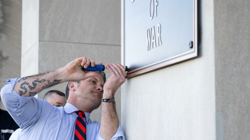 Secretary of Defense Pete Hegseth finishes the installation of a War Department plaque at the River Entrance in front of the Pentagon, Nov. 13, 2025.