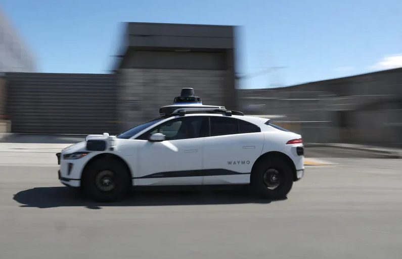 A Waymo car drives along a street on March 01, 2023 in San Francisco, California.