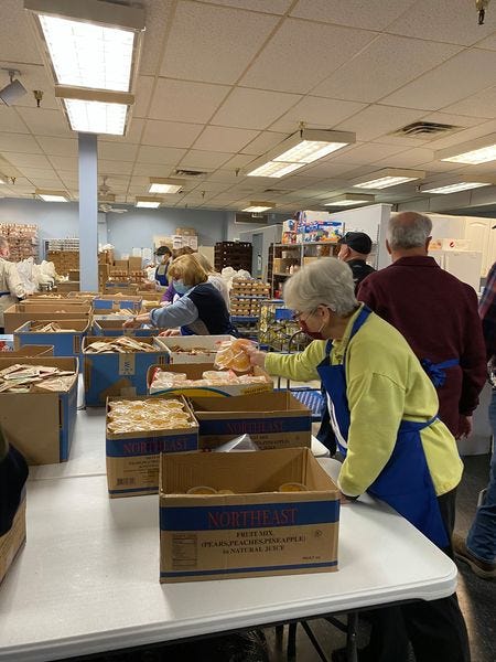 Volunteers help fill the backpacks