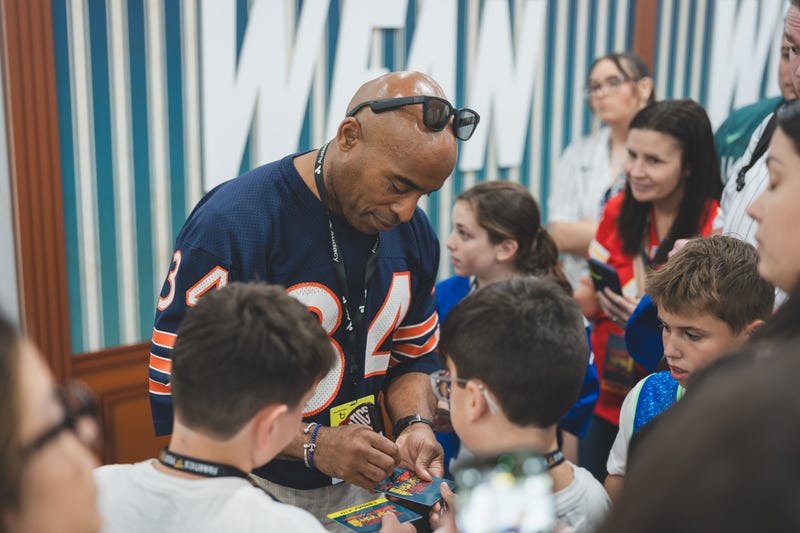 Tiki signs autographs