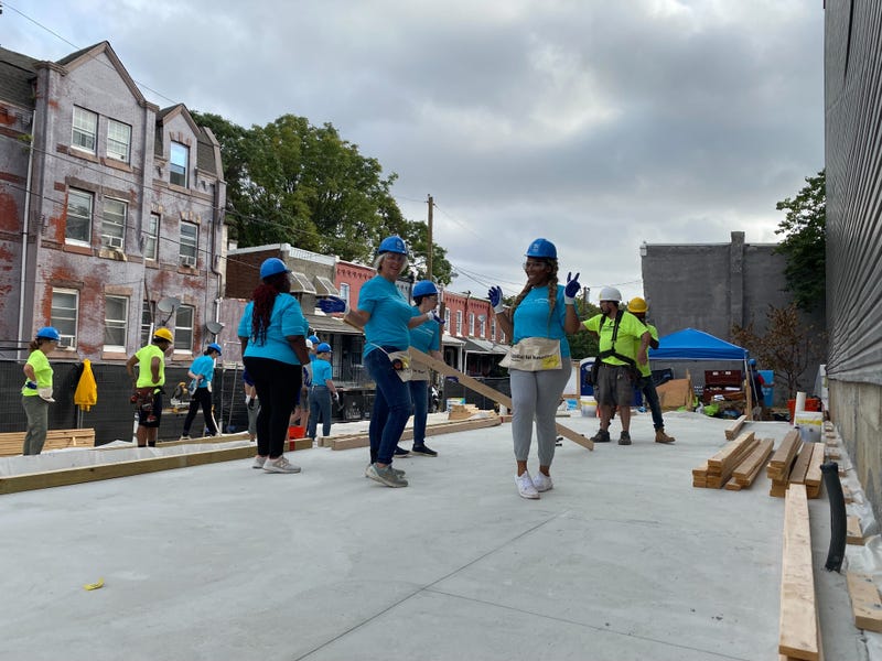 Some of the women from the volunteer builder crew work on the first of four houses going up in Mantua.