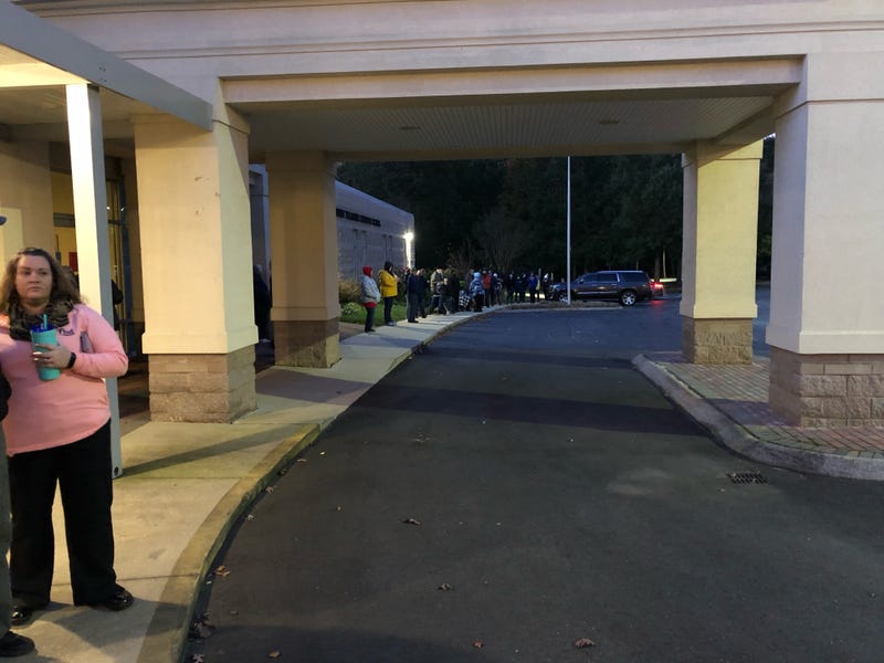 Voters wait outside a Wade Hampton precinct as the sun rises