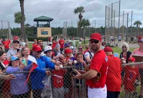 Cardinals pitcher Adam Wainwright signs autographs for fans at Spring Training 2022 in Jupiter, Florida.
