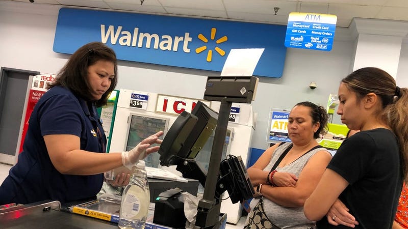 Customers look on as a Walmart cashier rings up their purchases at a Walmart store on August 15, 2019 in Richmond, California. 