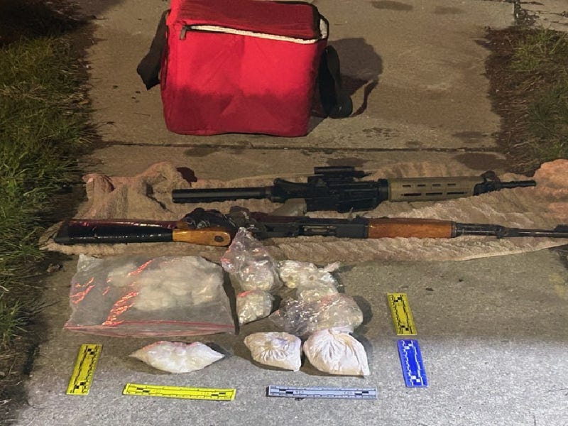 Assault rifles, bags of drugs seized in raid