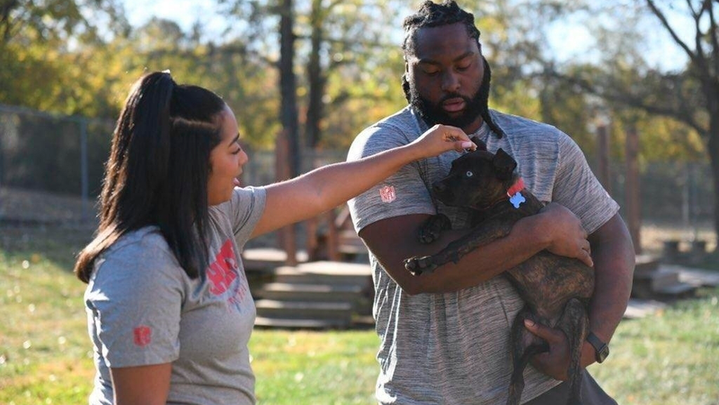 Chiefs player with puppy