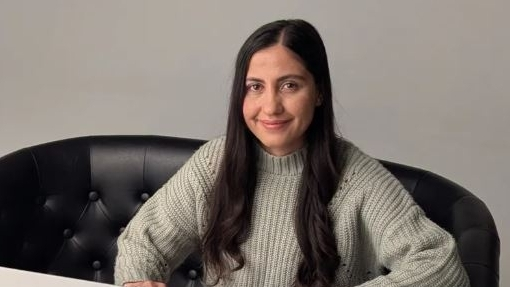 ZZ sits at a computer on the set of Queen of the Base preparing to speak with family members in Afghanistan who are still in hiding.