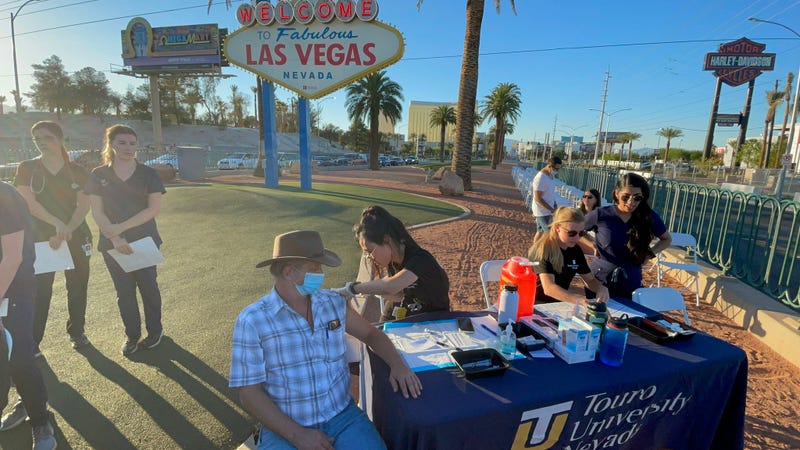 People receive their coronavirus vaccination in from of the Welcome to Fabulous Las Vegas Sign on the south end of the Las Vegas Strip