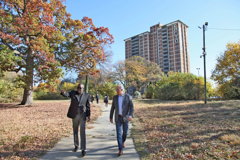 Former U.S. Sen. Bob Casey and Philadelphia Housing Authority President Kelvin Jeremiah walk the campus of Westpark Apartments, a public housing site that is being updated into modern, affordable housing.
