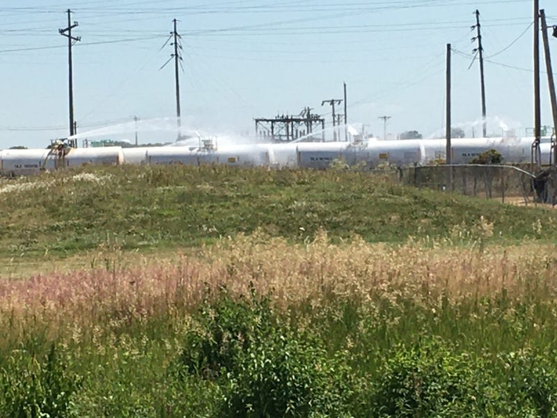 Water curtain being poured on to venting rail cars