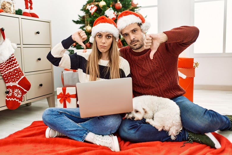 Christmas couple giving thumbs down