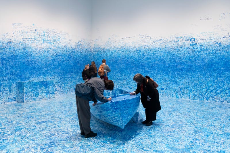 Visitors explore Yoko Ono’s "Add Colour (Refugee Boat) (1960/2016)" in "Yoko Ono: Music of the Mind," Tate Modern, London, February 15–September 1, 2024. © Yoko Ono