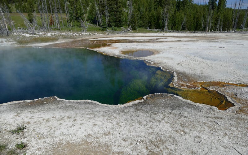 In this photo provided by the National Park Service is the Abyss Pool hot spring in the southern part of Yellowstone National Park, Wyo., in June 2015. Park officials say part of a foot, in a shoe, found floating in the hot spring on Tuesday, Aug. 16, 2022, is related to a July 31, 2022 death. No foul play is suspected, but the investigation continues.
