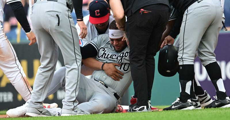 White Sox third baseman Yoan Moncada (10) is helped up after being injured while running to first base.