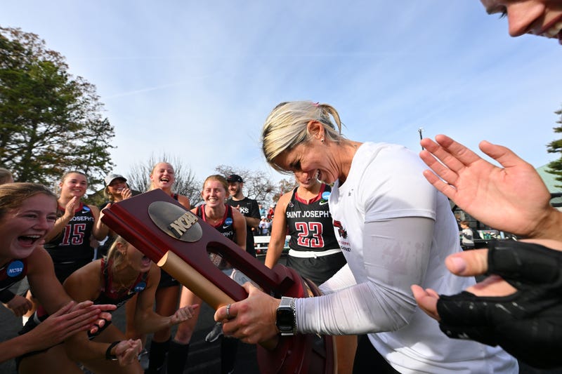 Head coach Hannah Prince celebrates with the Saint Joseph's University field hockey team.