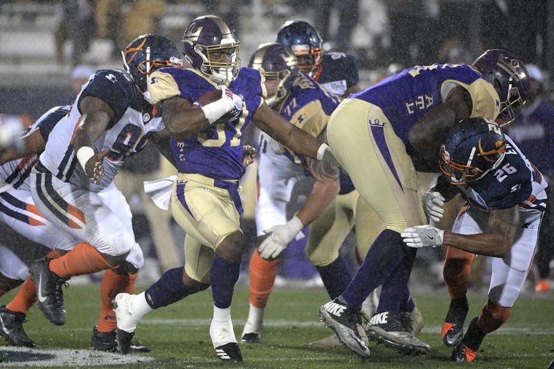Atlanta Legends running back Lawrence Pittman rushes in front of Orlando Apollos defensive end Anthony Moten Jr. during the second half of an Alliance of American Football game Saturday, Feb. 9, 2019 in Orlando, Florida.