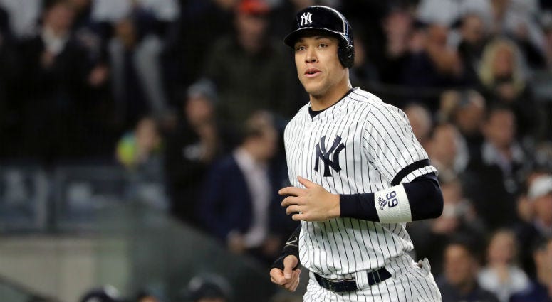 Aaron Judge of the Yankees comes home to score a run on a walk against the Houston Astros during the first inning in game four of the American League Championship Series at Yankee Stadium on October 17, 2019 in New York City.