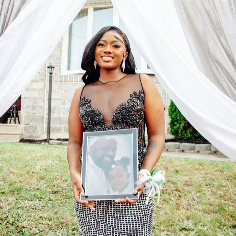 Aniyah holds an image of her father, who died when she was a little girl.