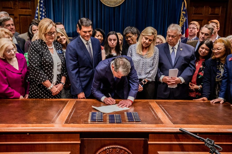 Georgia Governor Brian Kemp signs bill banning abortions after 6 weeks.