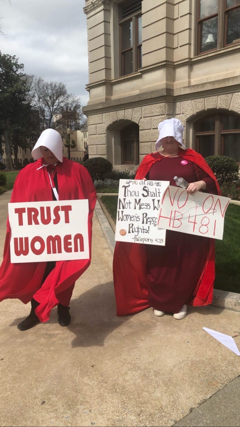 Dressed as characters from the fictional tv show and book "The Handmaids Tail" (about a totalitarian society) protestors have been assembling at the GA Capitol