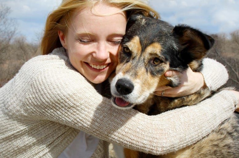 Woman Hugging German Shepherd Dog