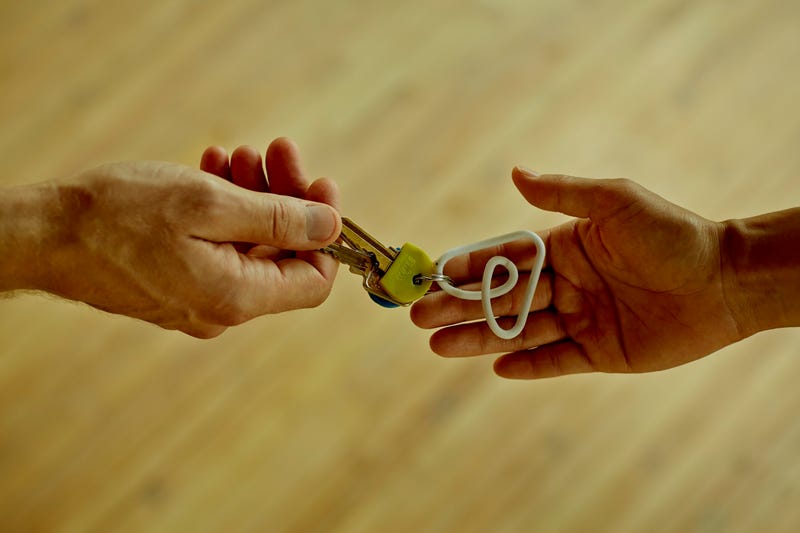 people exchanging a set of keys
